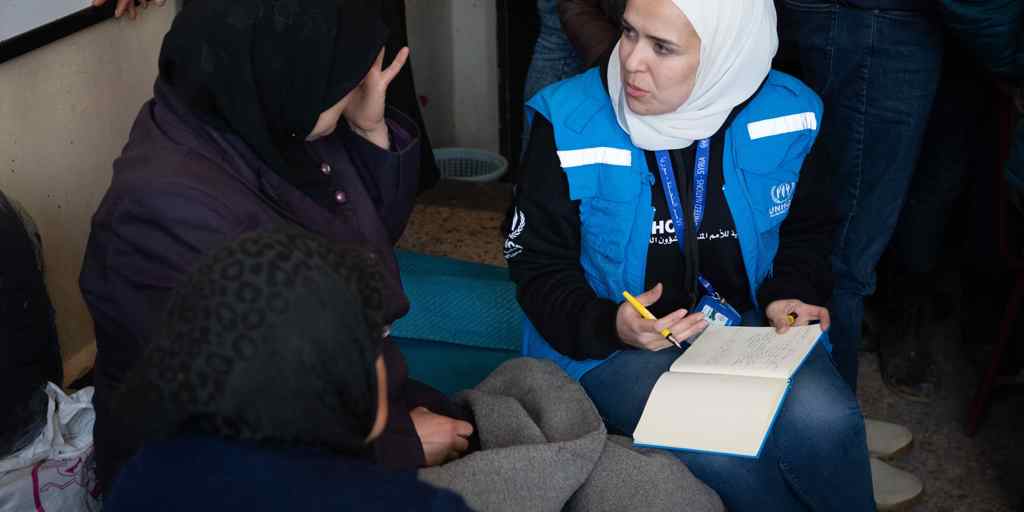 A woman receiving support from a UNHCR worked