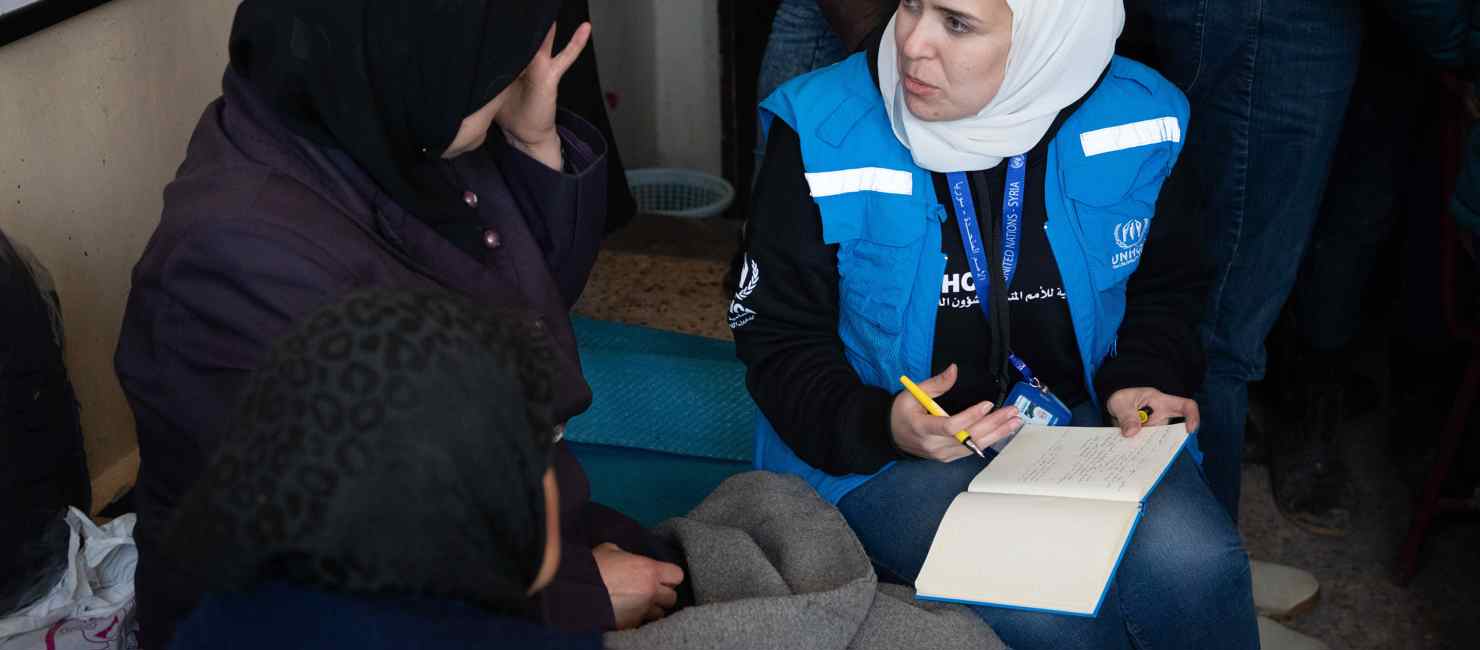 A woman receiving support from a UNHCR worked