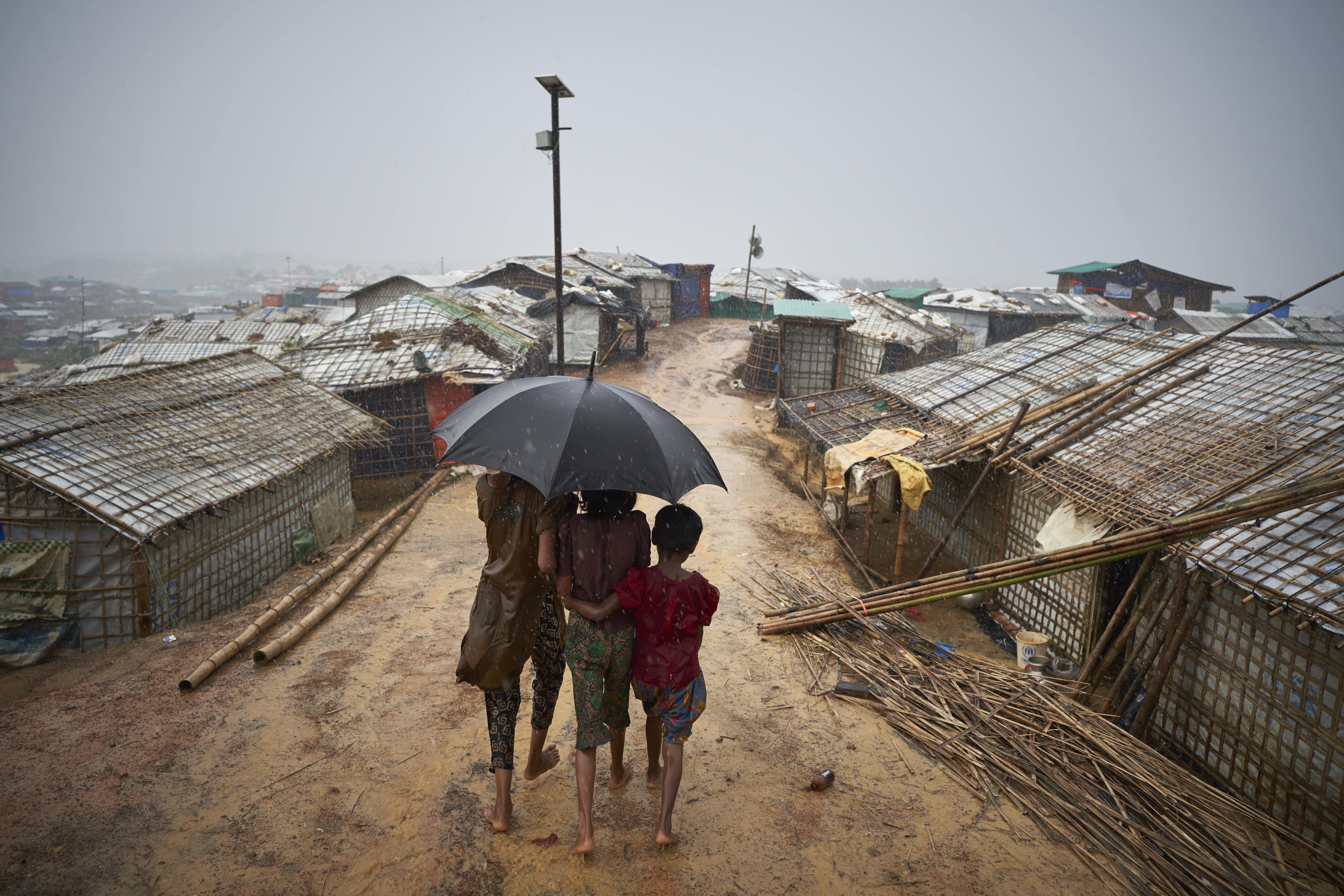 Bangladesh. Rohingya Refugees Walk Through A Heavy Downpour 