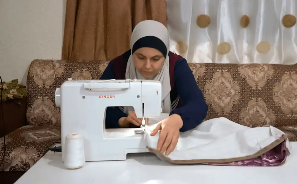cta_jordan_woman-works-at-her-sewing-machine