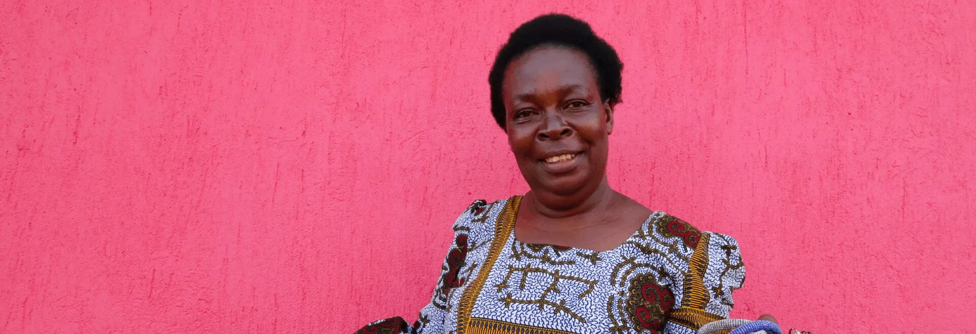 cta_uganda_congolese-woman-holds-brightly-coloured-handicrafts