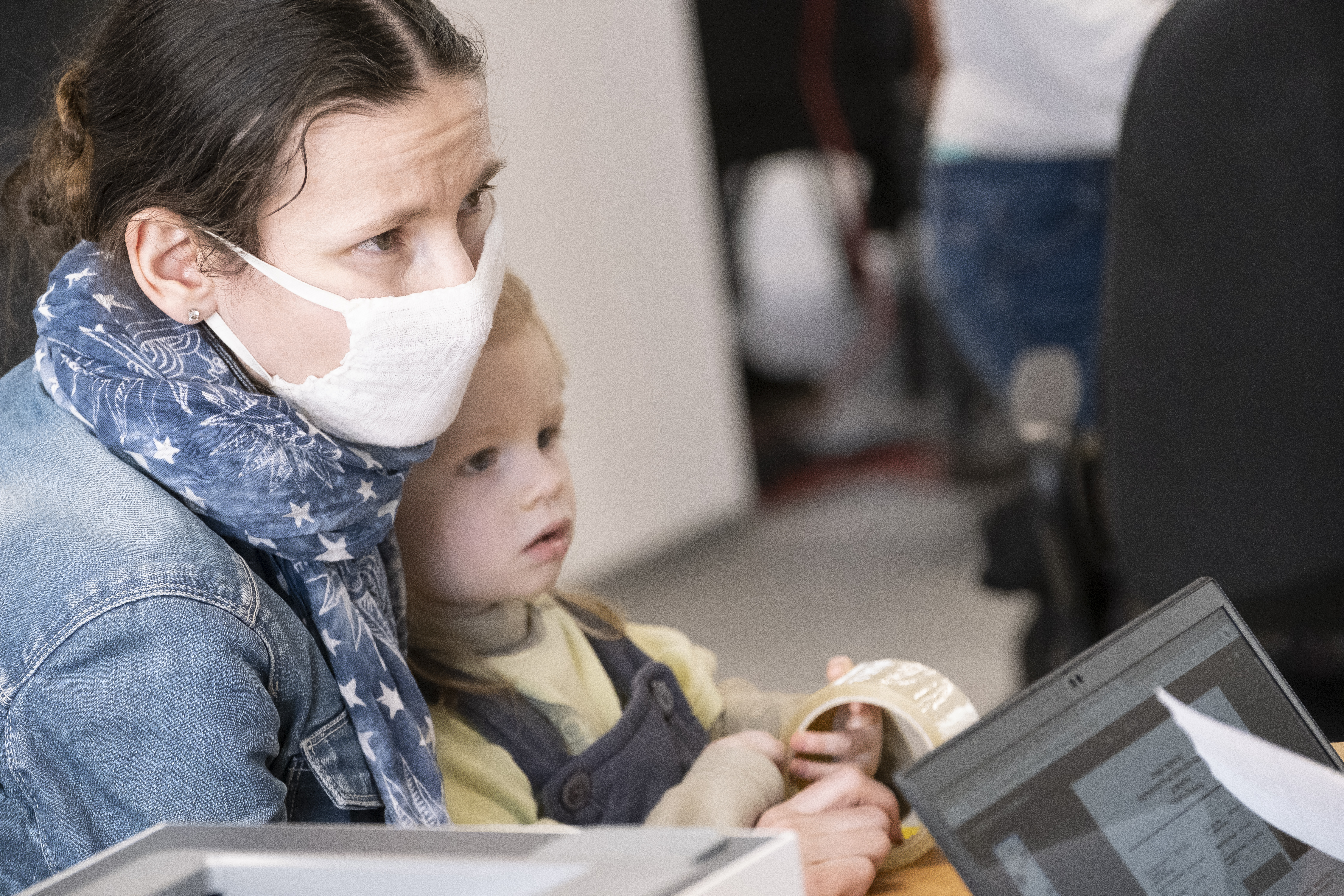 Rozalia Kucherowa with her son Andriy register at UNHCR’s cash assistance centre in Warsaw.