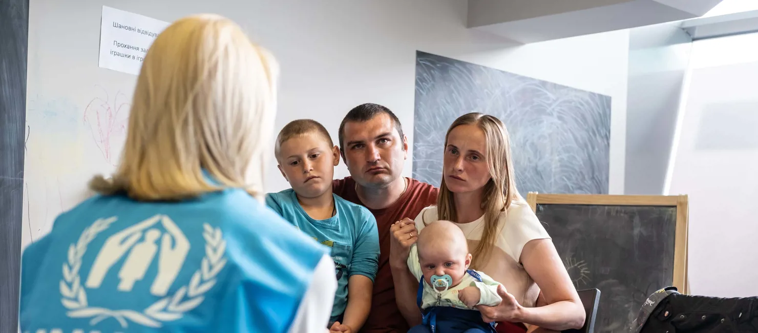 Ukrainian refugees, Andrei and Ludmila, visit UNHCR’s cash enrolment centre in Krakow Tauron Arena to register for cash assistance to cover their basic needs.