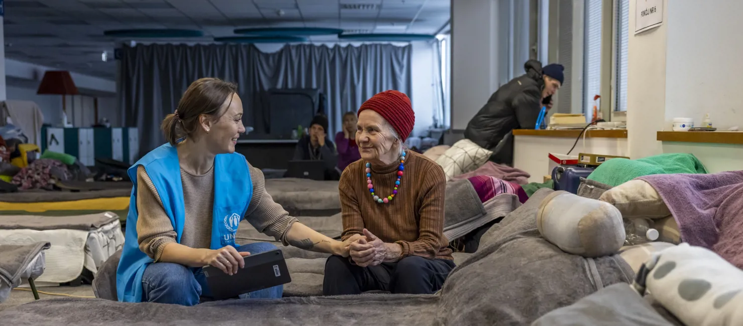 UNHCR protection monitor Svetlana Lokian is conducting an interview with Valentina