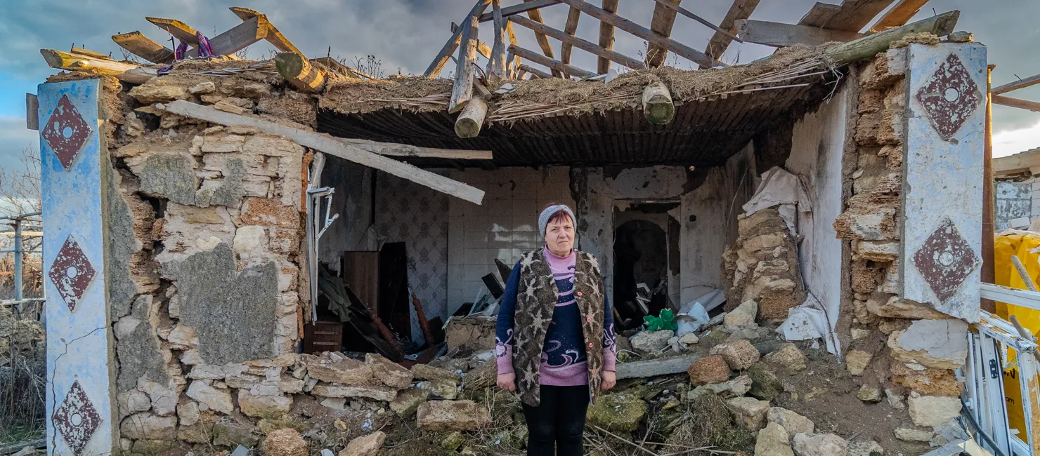 Ukraine_Valentyna stands outside her destroyed home in Mykolaiv, Ukraine