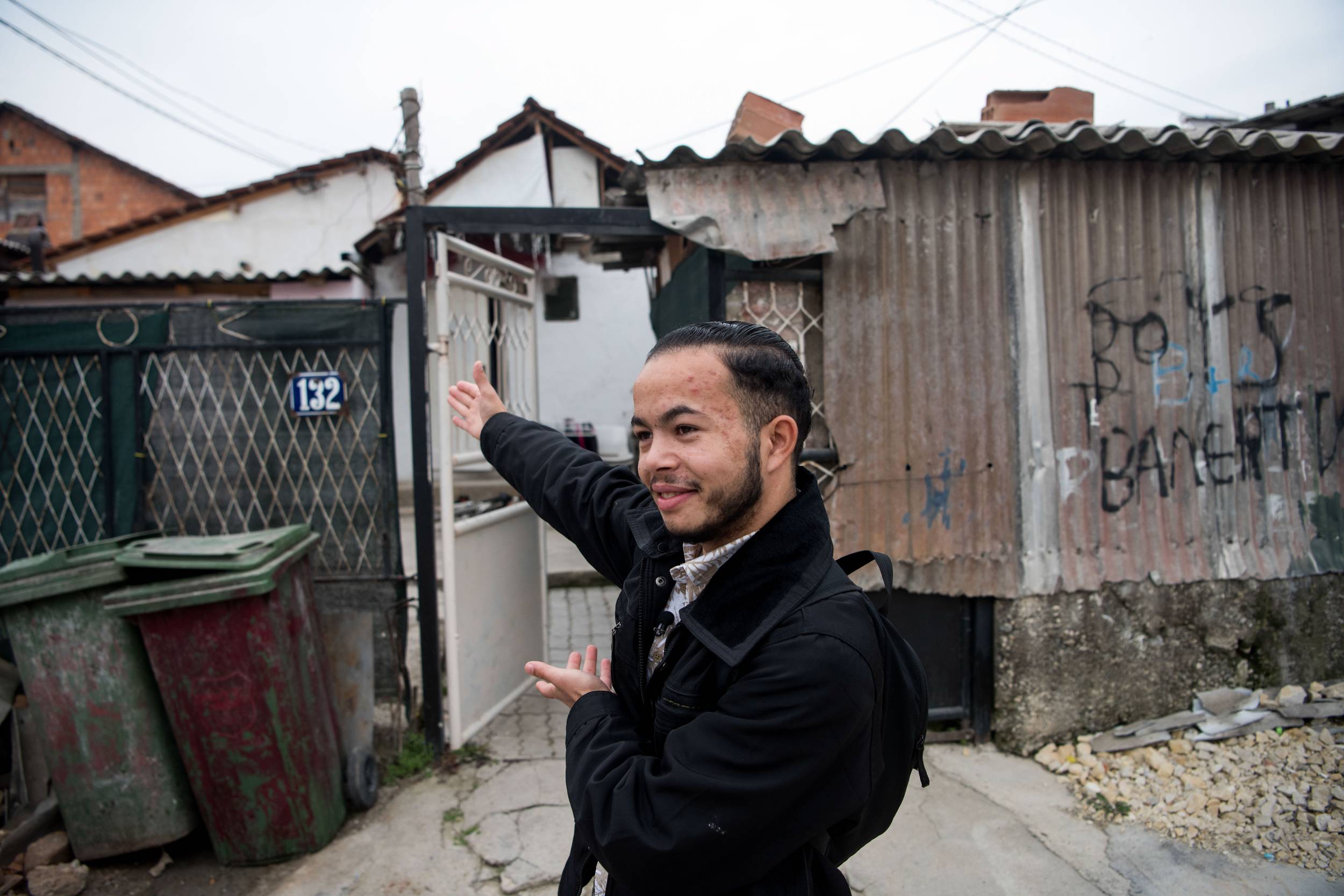 Valentin Rakip, 20, stands outside his home in North Macedonia. 