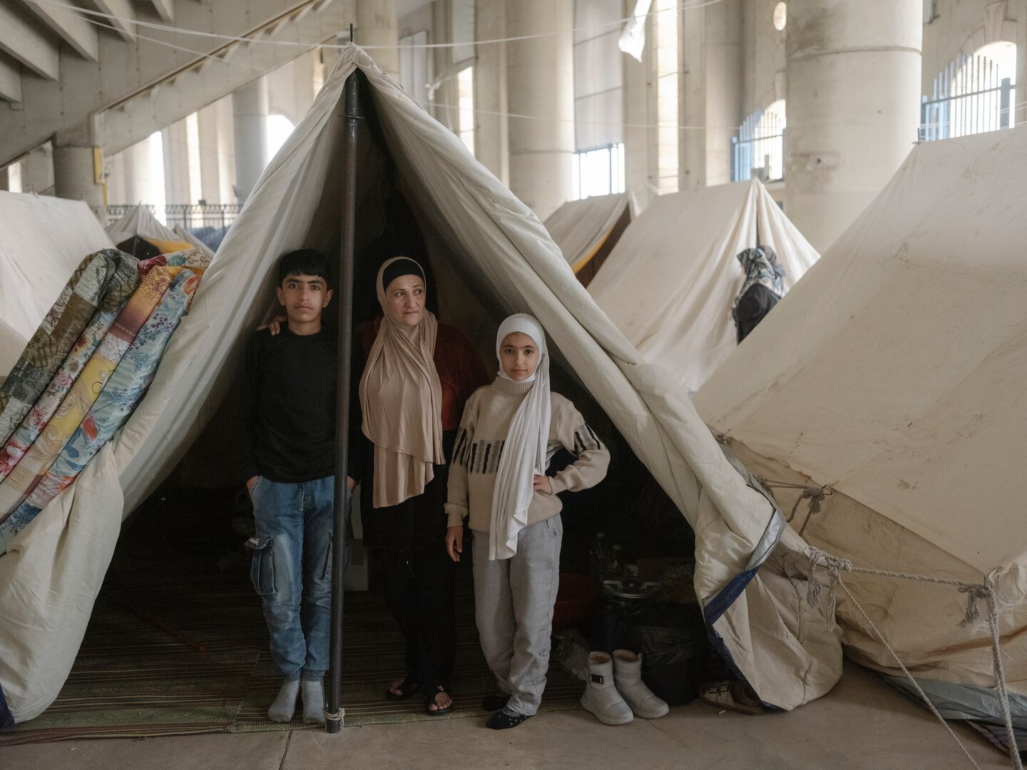 After Israeli attacks forced them to flee their home in southern Beirut, Sana and her two children are now sheltering in a sports stadium.